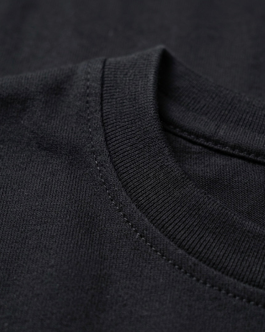Image 2: Bio-washed 180 GSM black engineered cotton fabric closeup — THE OUR STORE