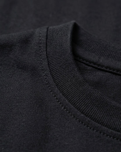 Image 2: Bio-washed 180 GSM black engineered cotton fabric closeup — THE OUR STORE
