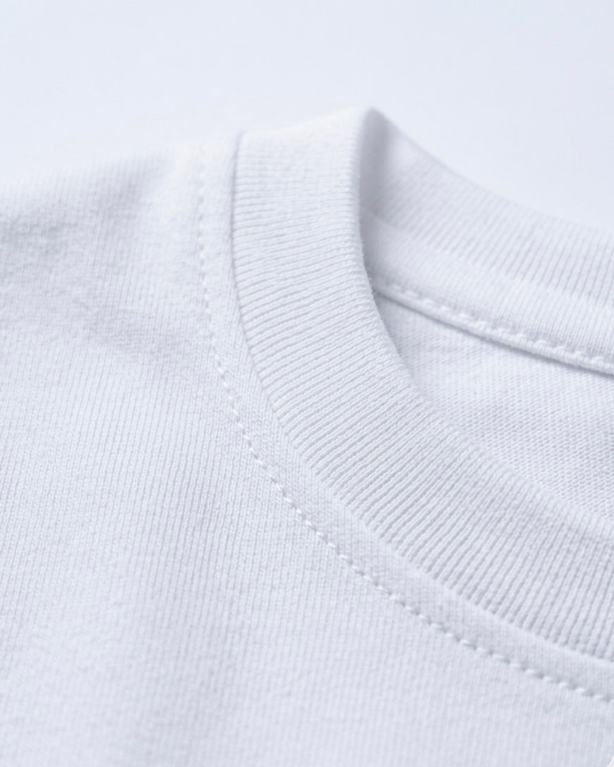 Image 2: Bio-washed 180 GSM white engineered cotton fabric macro closeup — THE OUR STORE